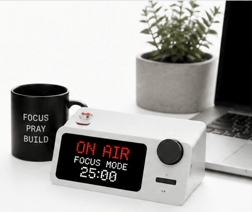 Focus. Pray. Build. — an on-air focus timer beside a laptop and a mug